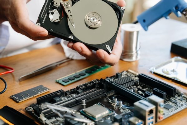 Technician repairing inside of hard disk drive by screwdriver. the concept of data, hardware, technician and technology. computer hardware, repairing, upgrade