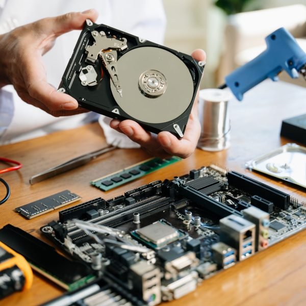 Technician repairing inside of hard disk drive by screwdriver. the concept of data, hardware, technician and technology. computer hardware, repairing, upgrade
